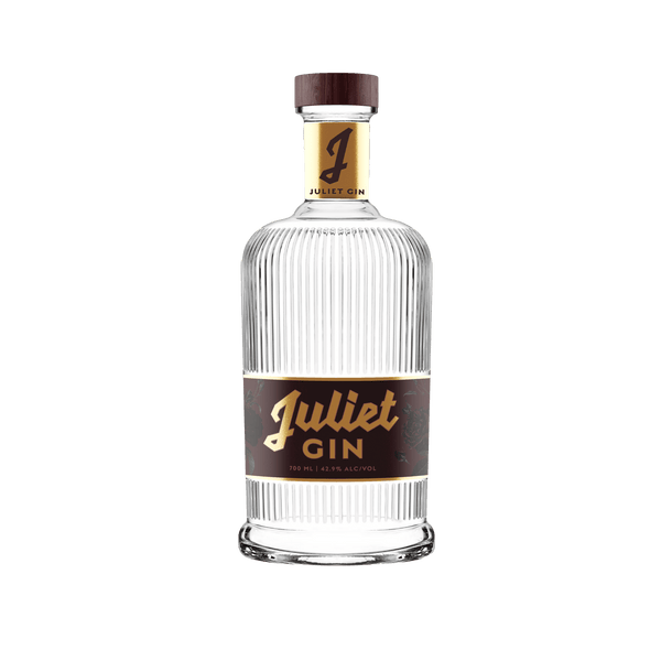 Juliet Gin - Paradigm Spirits Co. A beautiful glass bottle with a bold maroon and gold label.