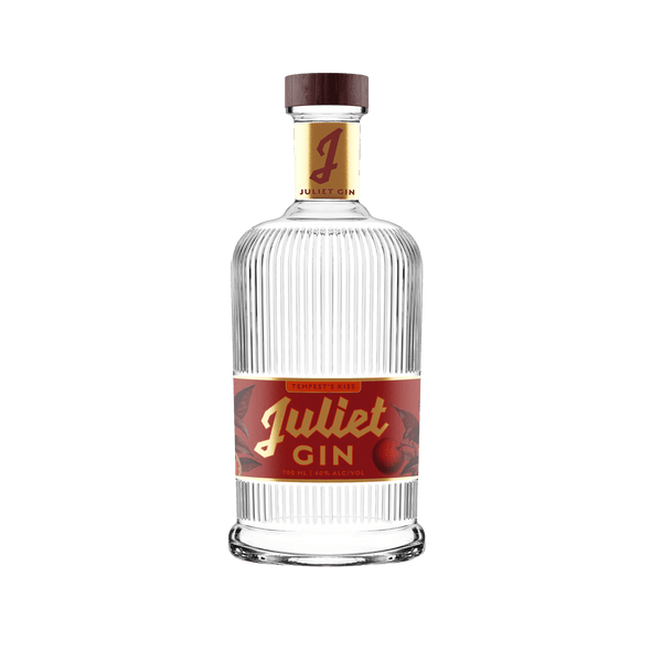 Juliet Gin: Tempest’s Kiss - Paradigm Spirits Co. A beautiful glass bottle with red and gold label accents.